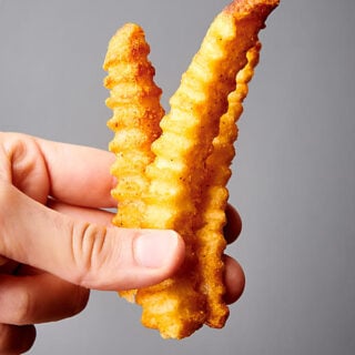 three air fried french fries held