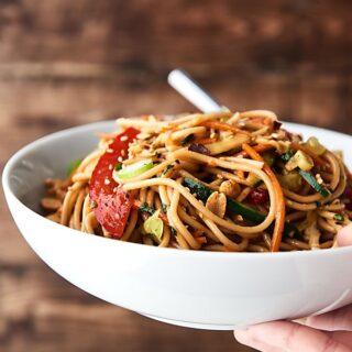 This Asian Pasta Salad Recipe is loaded with a homemade dressing: sesame oil, vinegar, lime juice, honey, soy sauce, spices, etc. -  fresh crunchy veggies: carrots, bell pepper, cucumbers - and other great mix-ins: noodles, peanuts, and cilantro! Light, fresh, quick and easy! showmetheyummy.com #pasta #salad #asian #summer #pastasalad