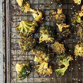 Roasted broccoli turned up a notch, this Asian Roasted Broccoli Recipe is healthy and full of coconut oil, soy sauce, spices, and just a touch of sriracha! Vegan. Can be gluten free. showmetheyummy.com #broccoli #vegan #glutenfree