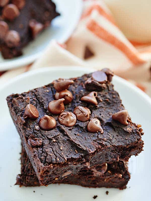 Two black bean brownies stacked from above side angle