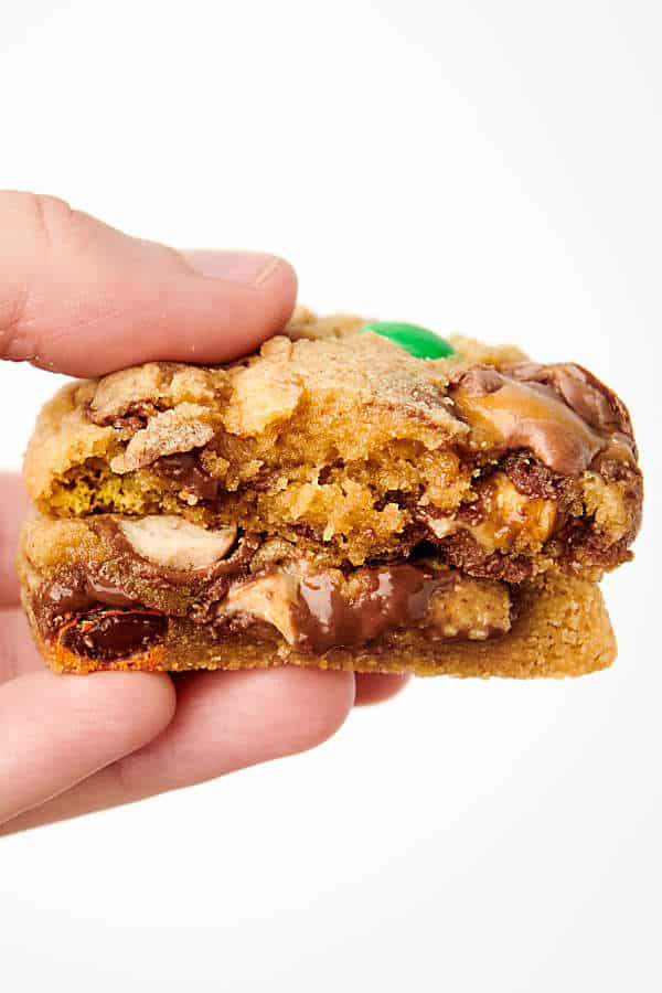 holding a candy cookie cut in half