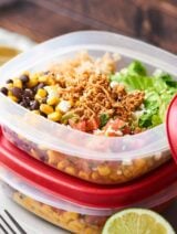 This Chicken Burrito Bowl Recipe is perfect for meal prep! They're quick and easy to make, healthy, gluten free, and loaded with crockpot chicken, beans, corn, a tangy dressing, and more! showmetheyummy.com #burritobowl #mealprep #chicken