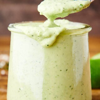 spoon in jar of cilantro lime sauce