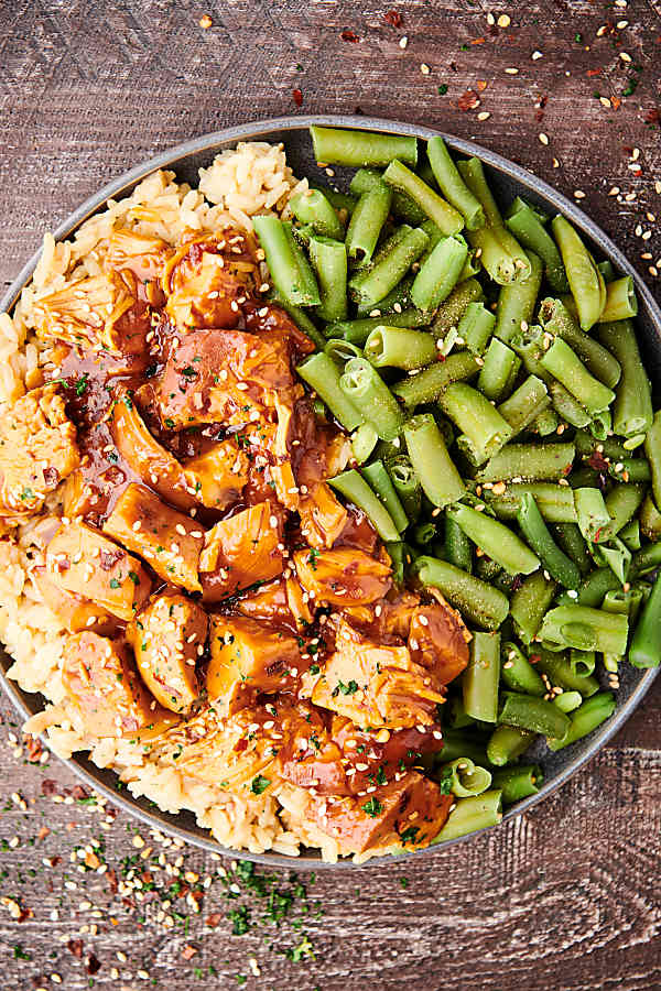 plate of crockpot bourbon chicken with green beans above