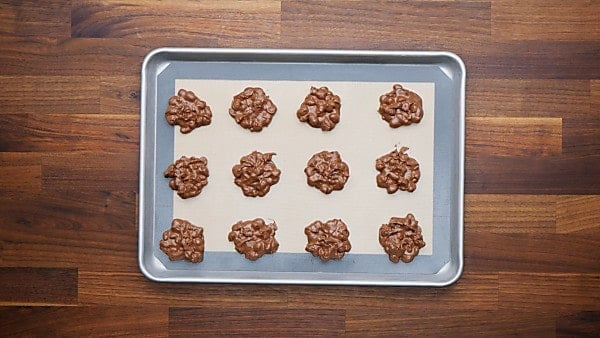 crockpot candy portioned out on baking sheet