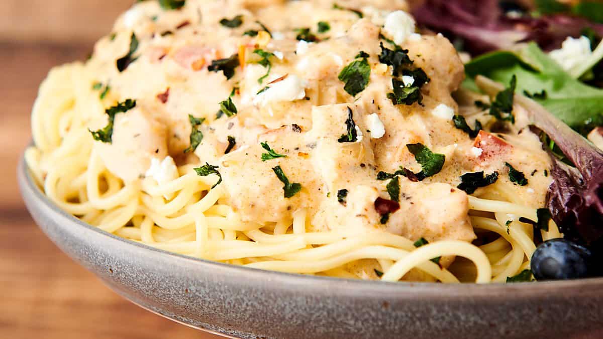 chicken spaghetti sprinkled with feta and herbs