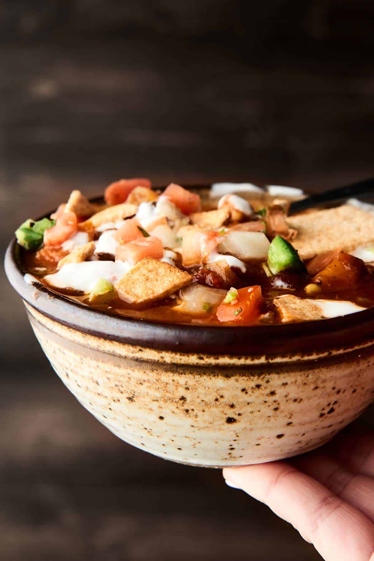 Bowl of vegetarian chili held