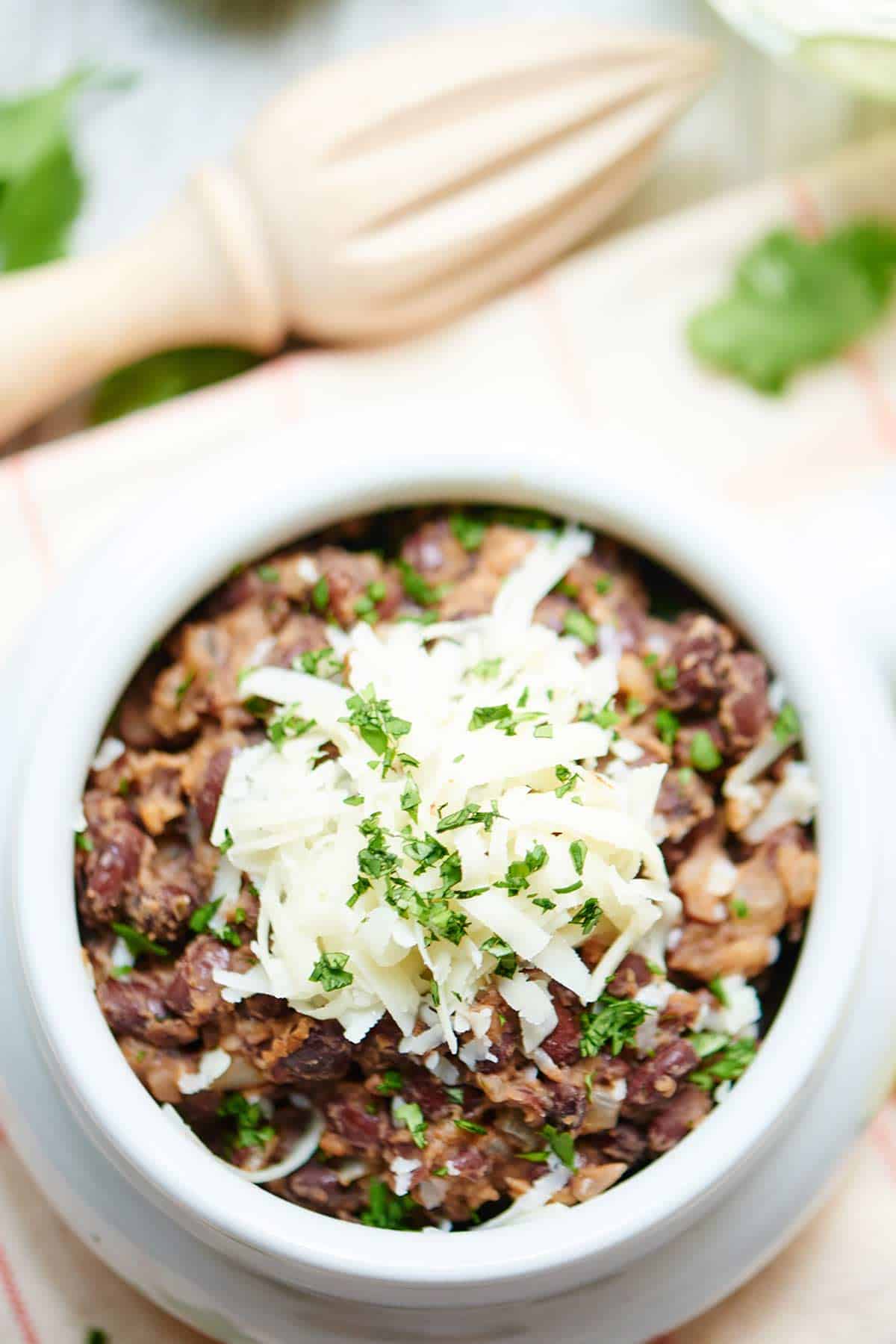 Bowl of easy black beans with cheese above