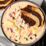 This Easy Reuben Soup Recipe only requires 12 ingredients! It's loaded with celery, onions, garlic, a touch of butter and flour, chicken broth, fat free half-and-half, Russian dressing, Yukon gold potatoes, sauerkraut, corned beef, and swiss cheese (plus salt and pepper). Served with toasted marbled rye bread! showmetheyummy.com #reuben #soup