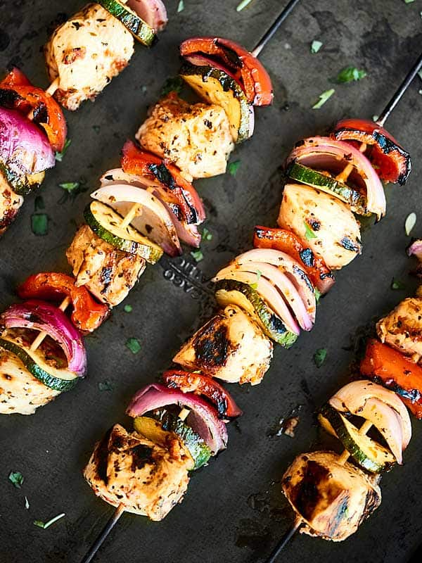 Greek kebabs on baking sheet above
