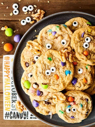 {New!} #ad These festive Halloween Monster Eye Walnut Cookies are SO cute and perfect for Halloween! A quick and easy cookie loaded with maple syrup, walnuts, mini m&ms, and candy eyeballs! showmetheyummy.com Made in partnership w/ @CAWalnuts #halloween #cookies #monster