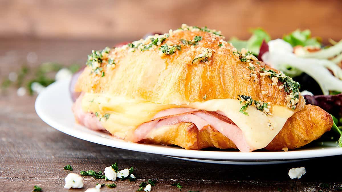 ham and cheese croissant on plate