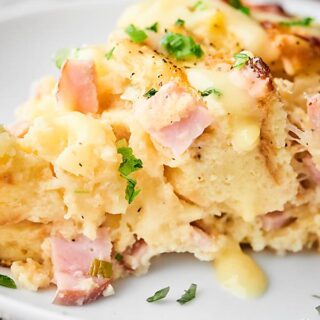 #ad This Hawaiian Eggs Benedict Casserole is easy, indulgent, and perfect for Spring brunches! Sweet rolls + Canadian bacon + pineapple and loads of cheese, YUM! showmetheyummy.com Made in partnership w/ @jonesdairyfarm