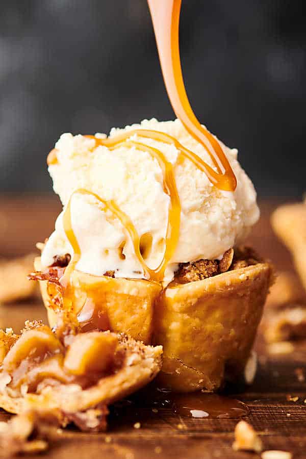 mini apple pie topped with scoop of ice cream and drizzled with caramel