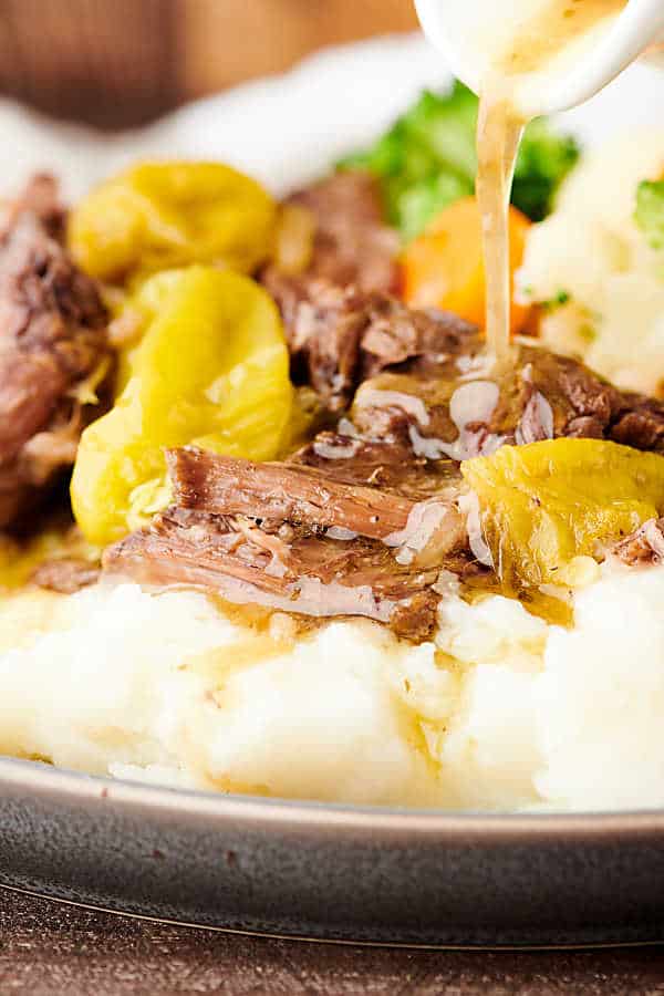 closeup of mississippi roast on plate with mashed potatoes