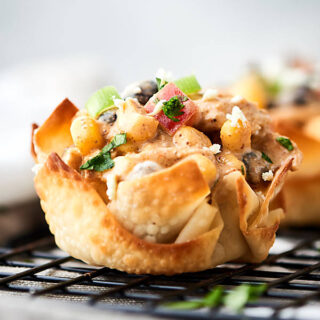 Southwestern chicken salad cups. Baked wonton cups filled with chicken, corn, beans, peppers, greek yogurt, lime, and taco seasonings! About 100 calories per cup! Great for easy lunches, snacks, or a big party! showmetheyummy.com #wonton #chickensalad