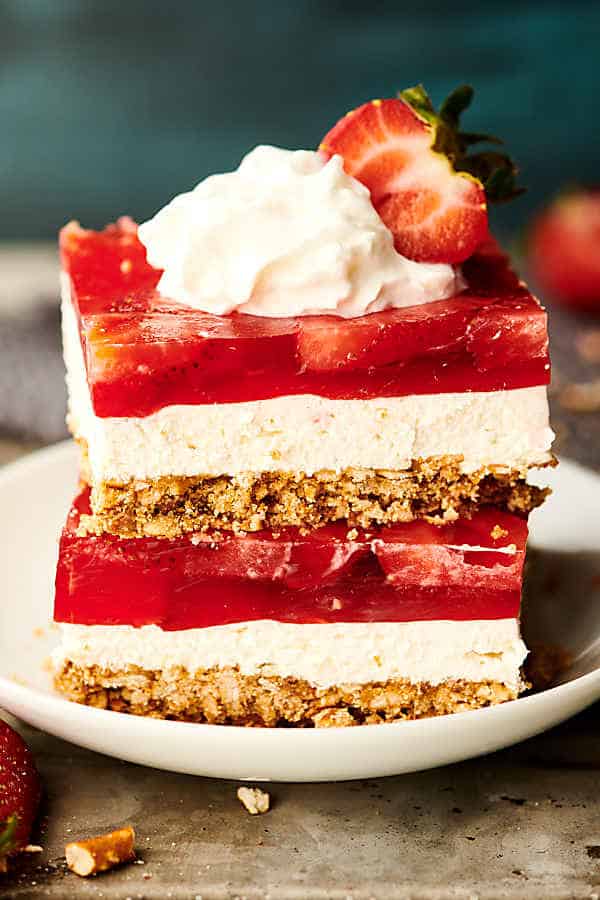 strawberry pretzel salad stacked with whipped cream