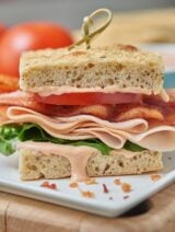 This turkey bacon bravo sandwich is just a little bit chewy from the focaccia, juicy from the tomatoes, fresh from the lettuce, crisp from the bacon, and smoky from the turkey and gouda. And the special sauce? Well, that adds just a little acidity and a spicy kick to round out the whole thing! www.showmetheyummy.com #sandwich #panera #bread #turkeybaconsandwich #lunch