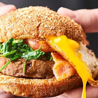 #ad Turkey Brunch Burger Recipe. Because why should grilling JUST be for dinner?! A grilled turkey burger topped with cheese, spinach, bacon, a gooey egg, and a drizzle of maple syrup! showmetheyummy.com #SwitchCircle #JennieO