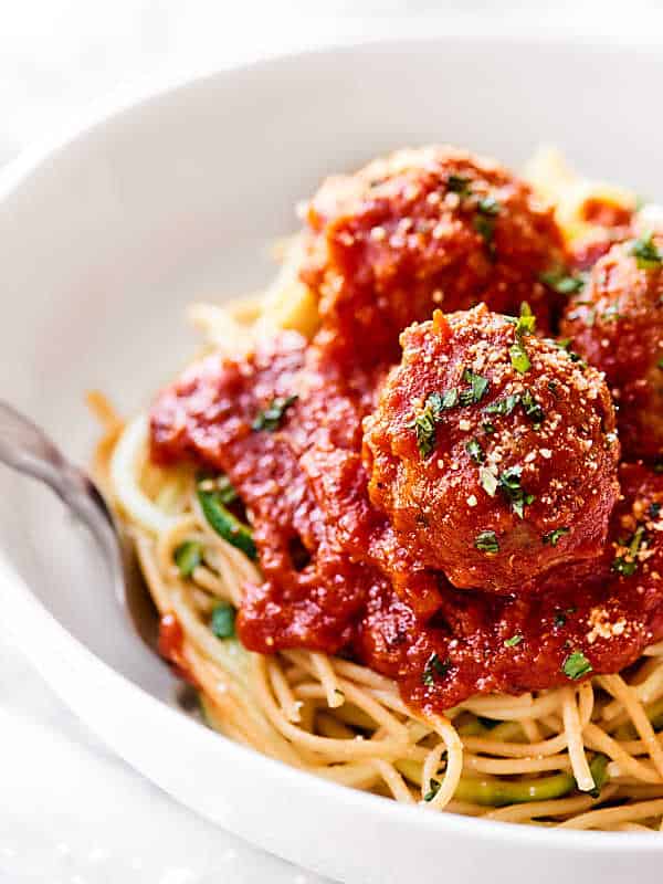 Healthy turkey meatballs over bowl of noodles