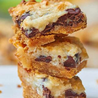 These ugly duckling bars may not be much to look at, but they sure taste good! Start with a graham cracker crust and pile on gooey chocolate chips, sweet coconut flakes, and sweetened condensed milk! www.showmetheyummy.com #bars #dessert #chocolatechips #coconut #sweetenedcondensedmilk
