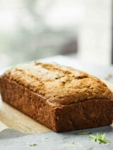 Tons of zucchini on your hands? Vegan Zucchini Bread tooooo the rescue! It's tender, it's moist, and it's loaded with cozy cinnamon, sweet brown sugar, coconut oil, and of course, plenty of zucchini! showmetheyummy.com #zucchinibread #vegan