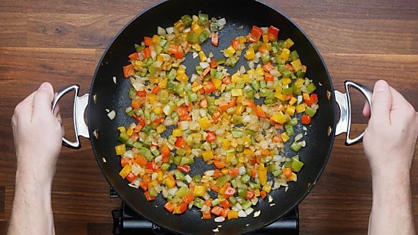 onions and peppers cooked in skillet